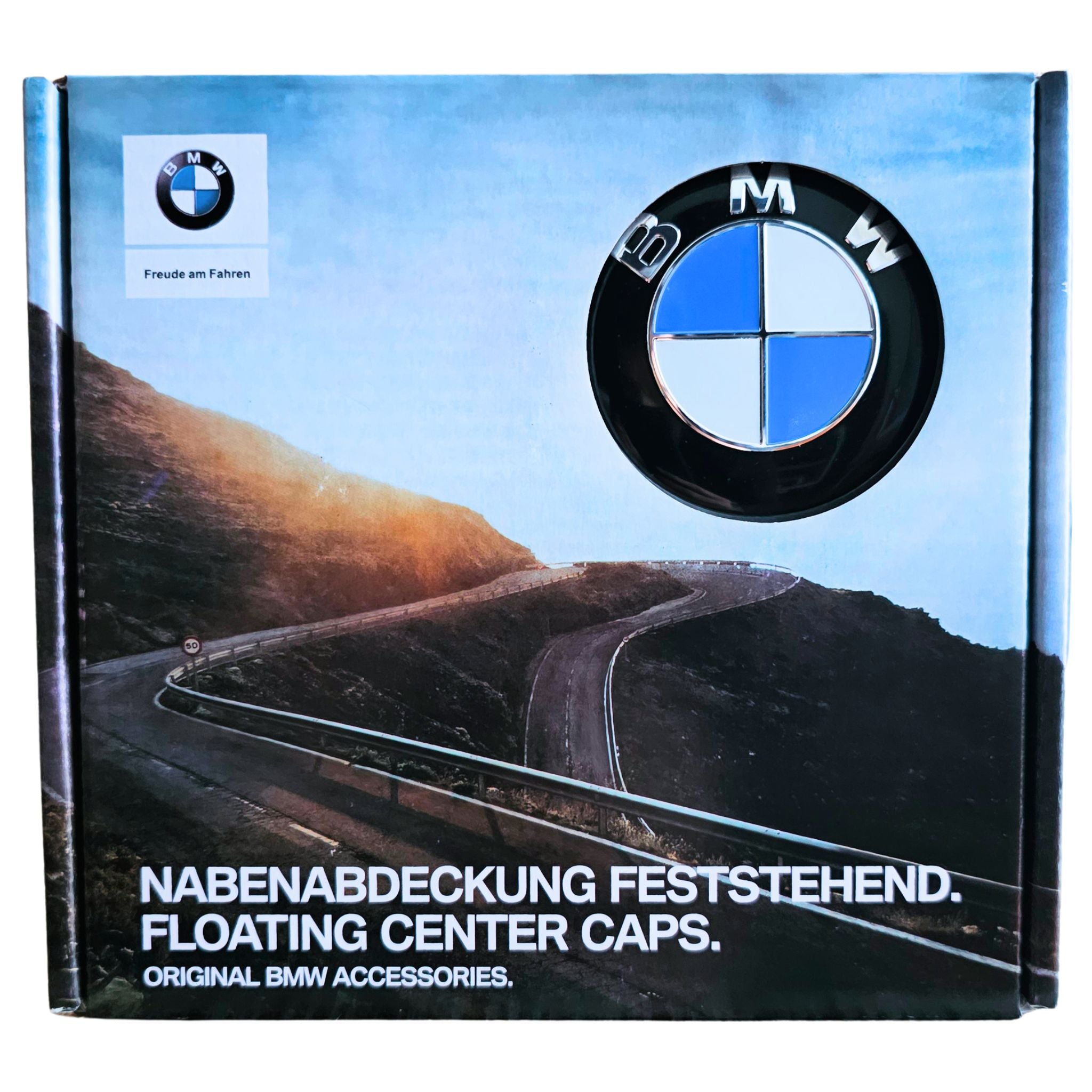 Box packaging for BMW floating center caps, featuring the BMW logo, a winding mountain road photo, and German and English text reading 'FLOATING CENTER CAPS' and 'ORIGINAL BMW ACCESSORIES.'.