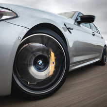 Load image into Gallery viewer, Car driving with BMW floating centre cap fitted
