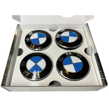 Load image into Gallery viewer, Open box with 4 BMW floating wheelcaps inside
