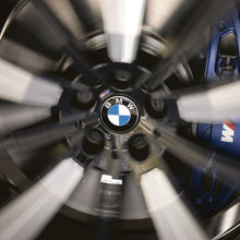 Load image into Gallery viewer, Alloy wheel spinning with BMW floating centre cap fitted
