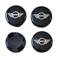 Four mini wing logo wheel centre hub caps on a white background