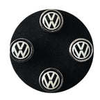 Set of Volkswagen VW tyre valve caps on a black base