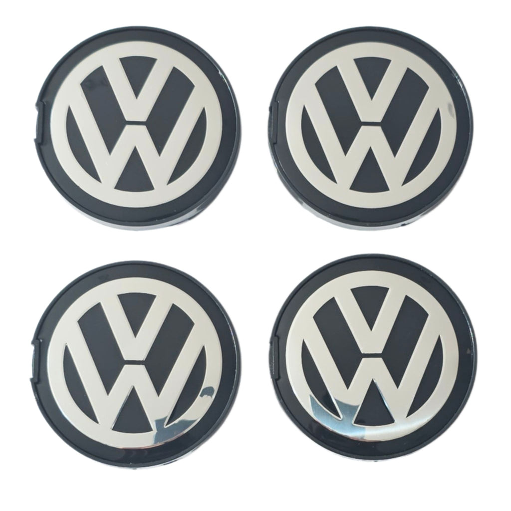 Four 63mm VW Volkswagen logo wheel center caps on a white background