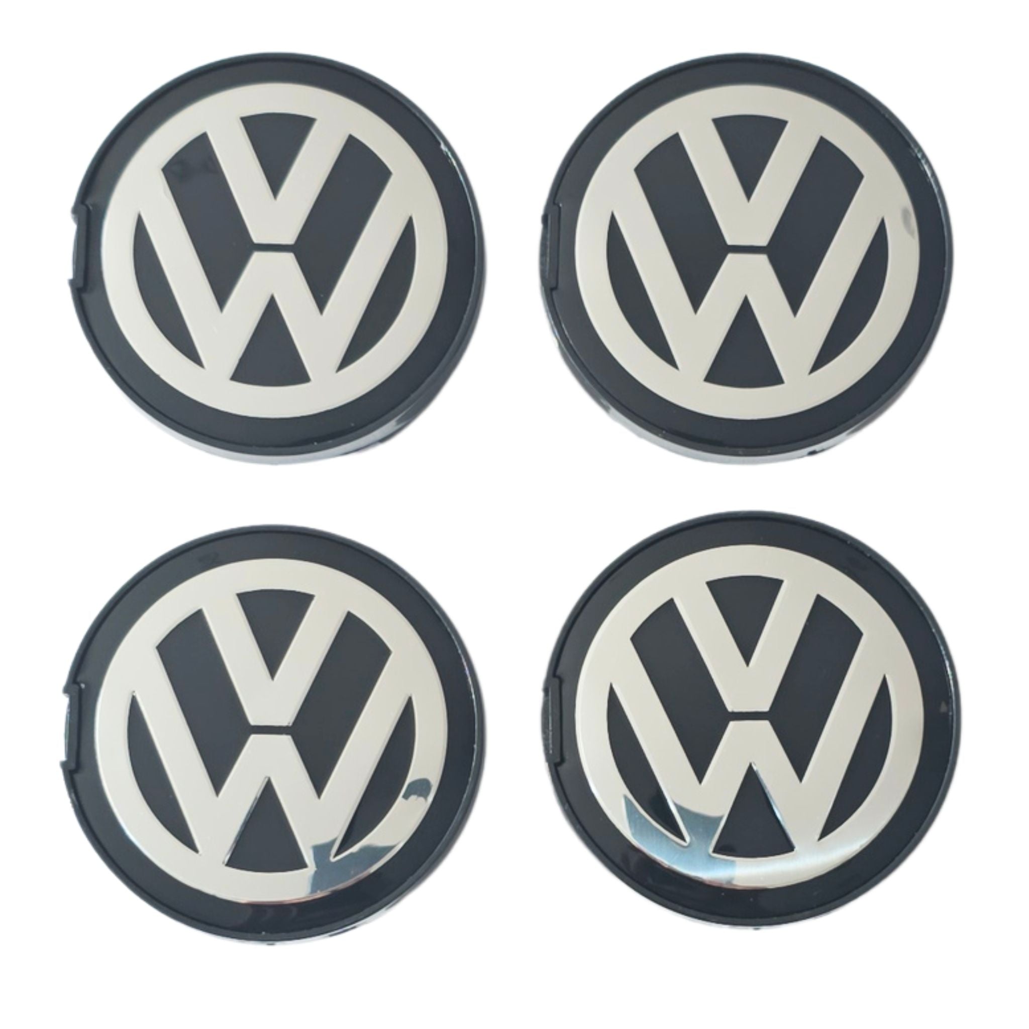 Four 63mm VW Volkswagen logo wheel center caps on a white background