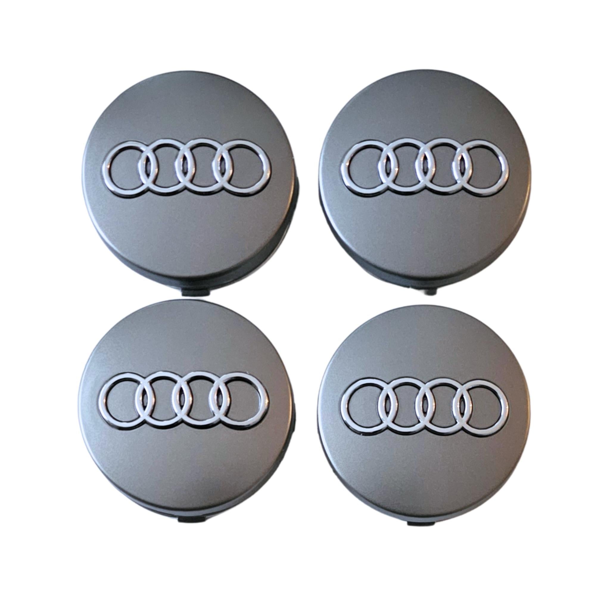 Four Audi 60mm Silver Grey wheel center caps on a white background