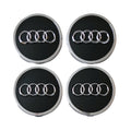 Four Audi 61mm black wheel centre caps on a white background