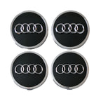 Four Audi 61mm black wheel centre caps on a white background