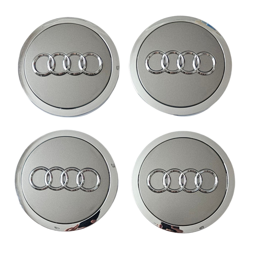 Four Silver Grey Audi logo car wheel center caps on a white background