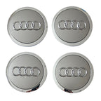 Four Silver Grey Audi logo car wheel center caps on a white background