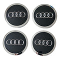 Four 69mm Black Audi wheel centre caps on a white background