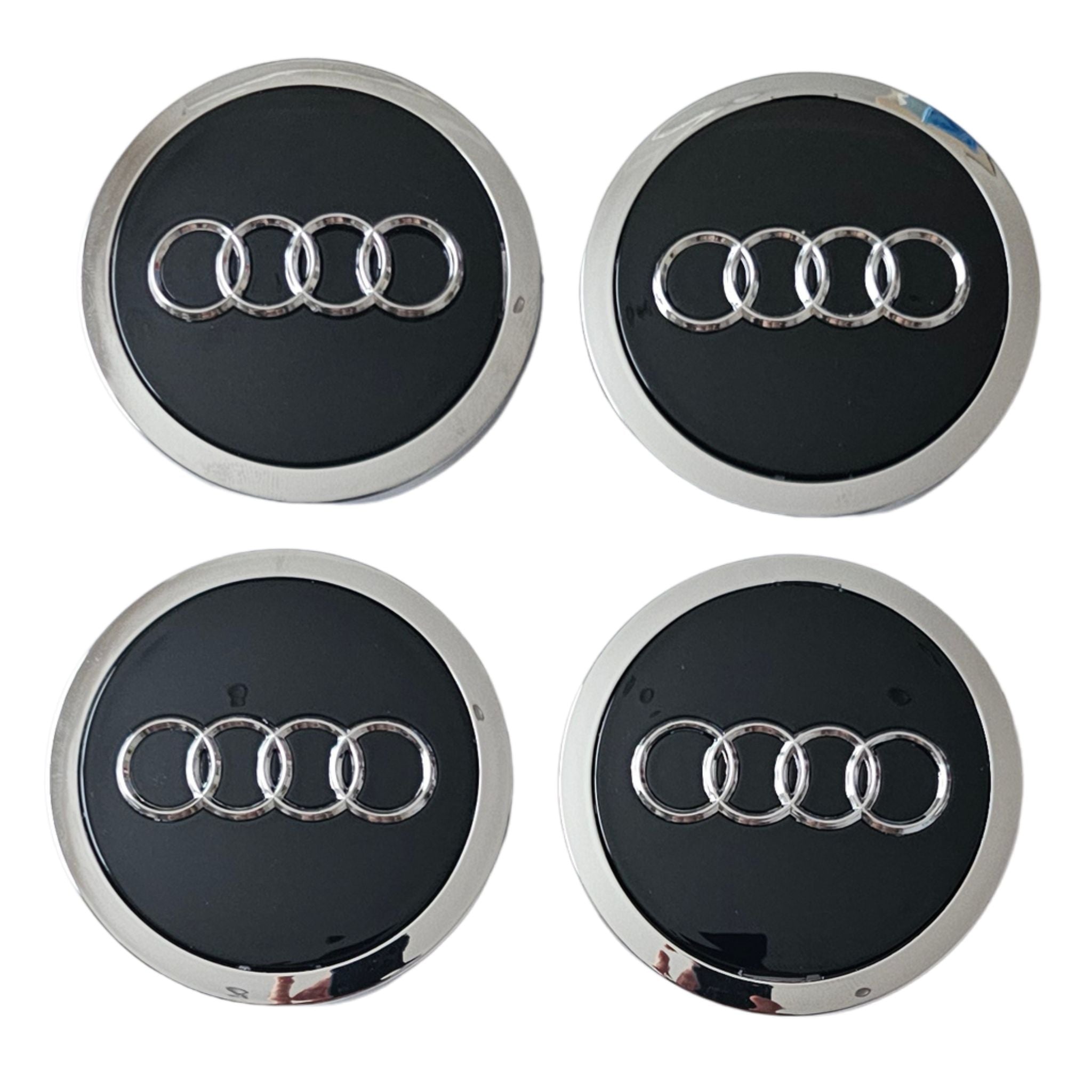 Four 69mm Black Audi wheel centre caps on a white background