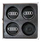 set of four Audi Dynamic Floating Wheel Centre Caps 61mm in packaging on a white background