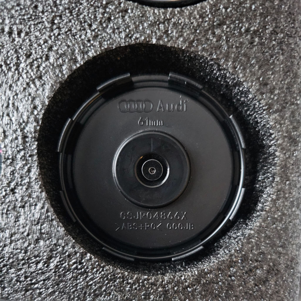 Close-up of rear of  61mm Audi floating dynamic wheel centre cap in packaging.
