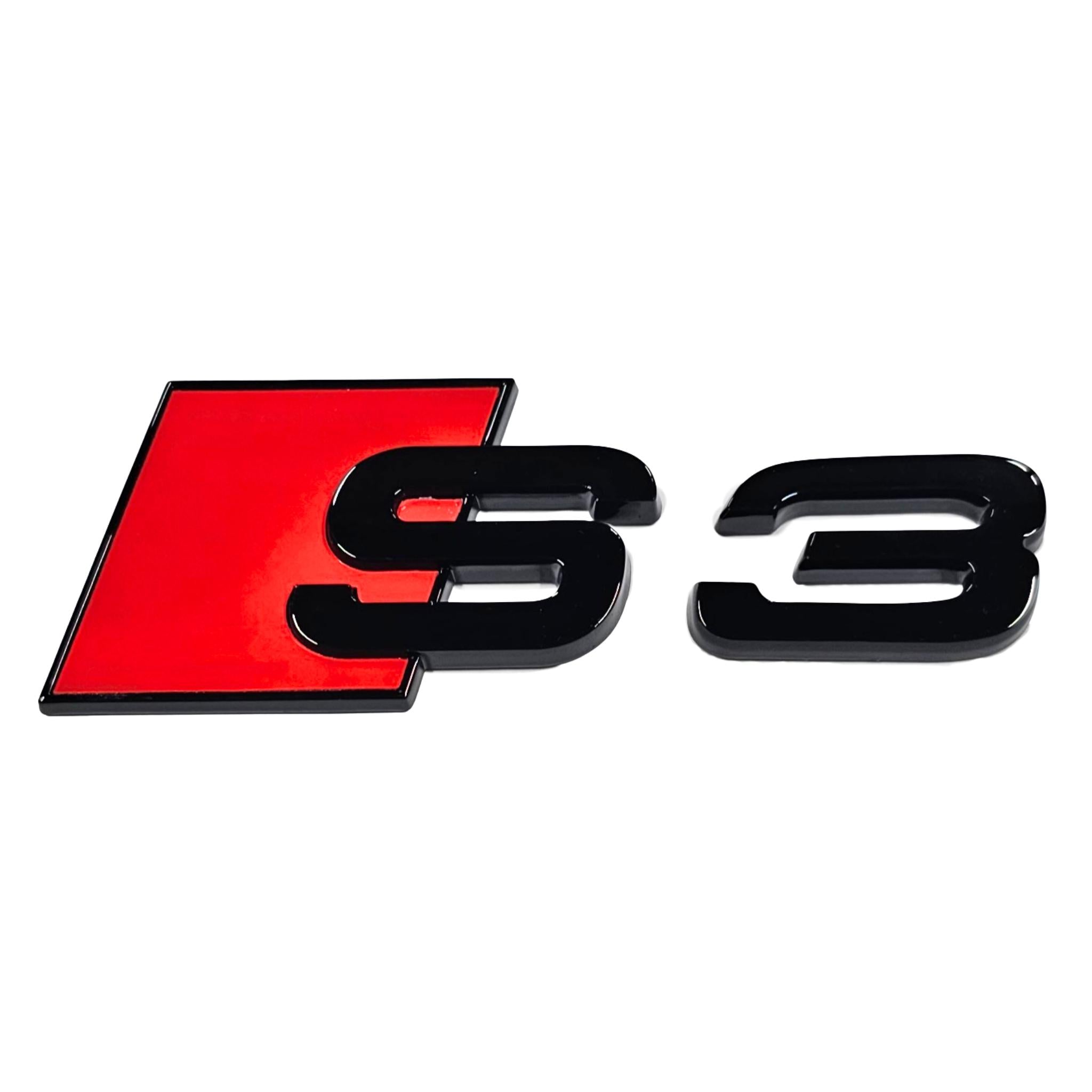 Gloss Black Audi S3 rear badge with red accents on a white background