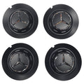 Four black Mercedes 147mm wheel center caps with emblem on a white background