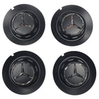 Four black Mercedes 147mm wheel center caps with emblem on a white background