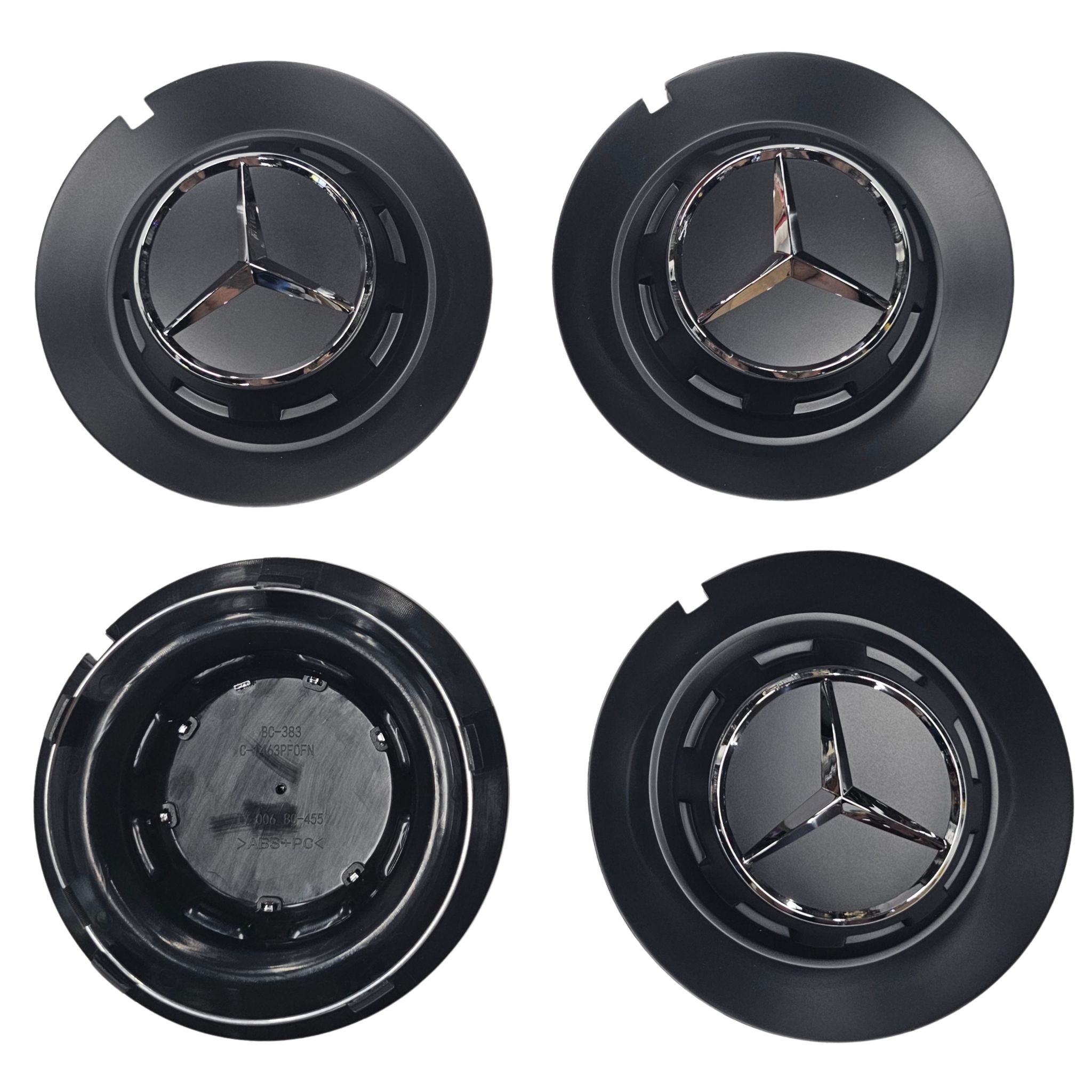 Four black Mercedes 147mm  wheel center caps one showing rear side on a white background