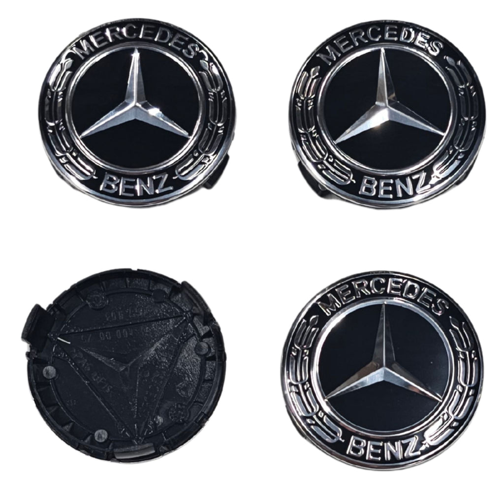 Four Black Mercedes-Benz Wheel Centre Cap emblems on a white background one flipped to show rear
