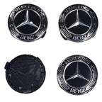 Four Black Mercedes-Benz Wheel Centre Cap emblems on a white background one flipped to show rear
