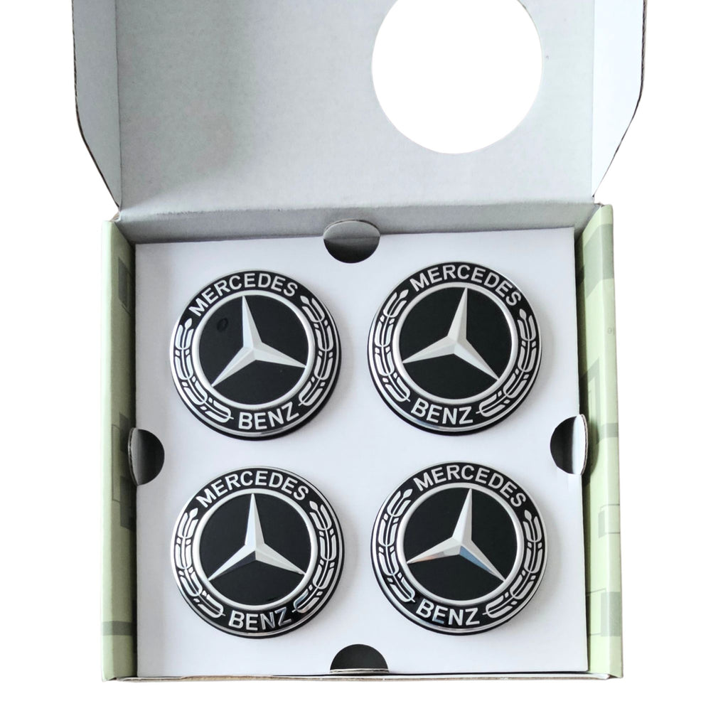Four 75mm Mercedes-Benz Dynamic Floating Centre Caps Black inside an open white presentation box.