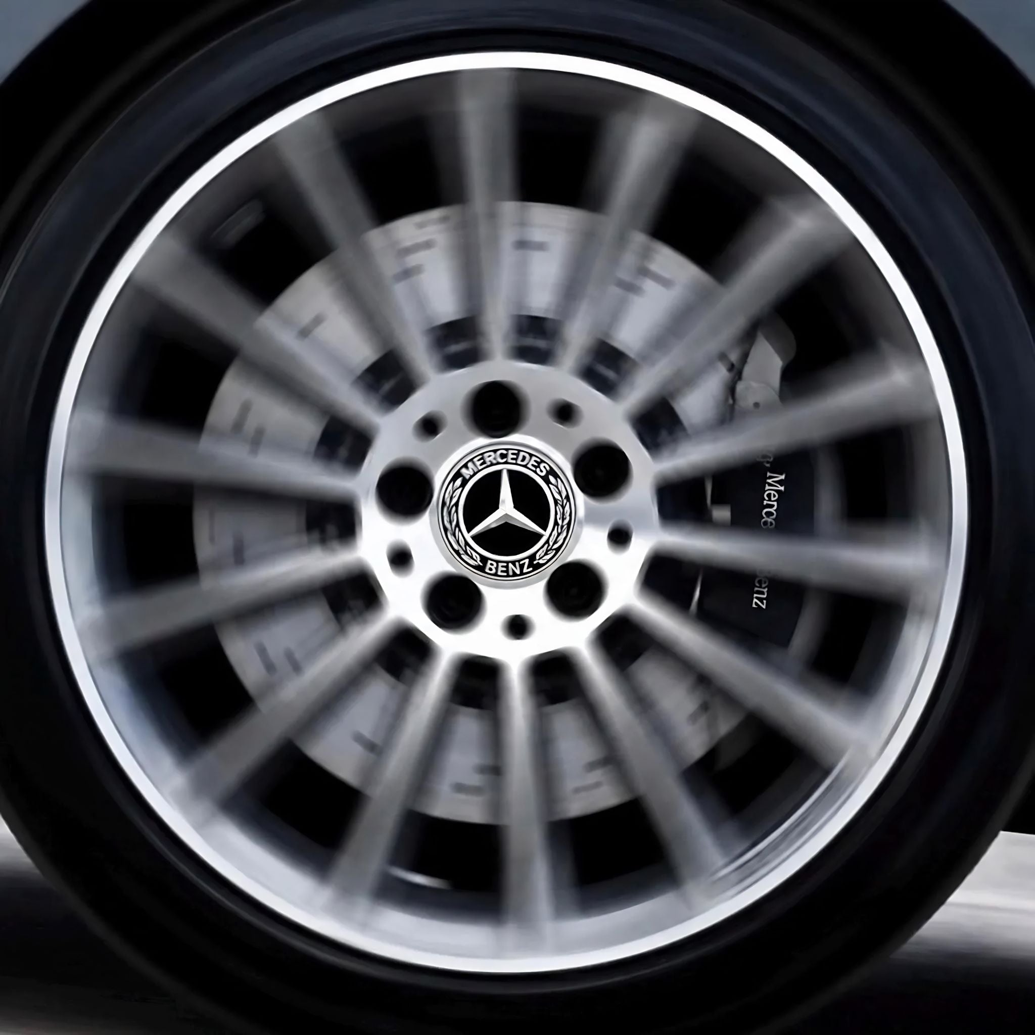 Close-up of a Mercedes-Benz alloy wheel with a dynamic floating centre cap fitted