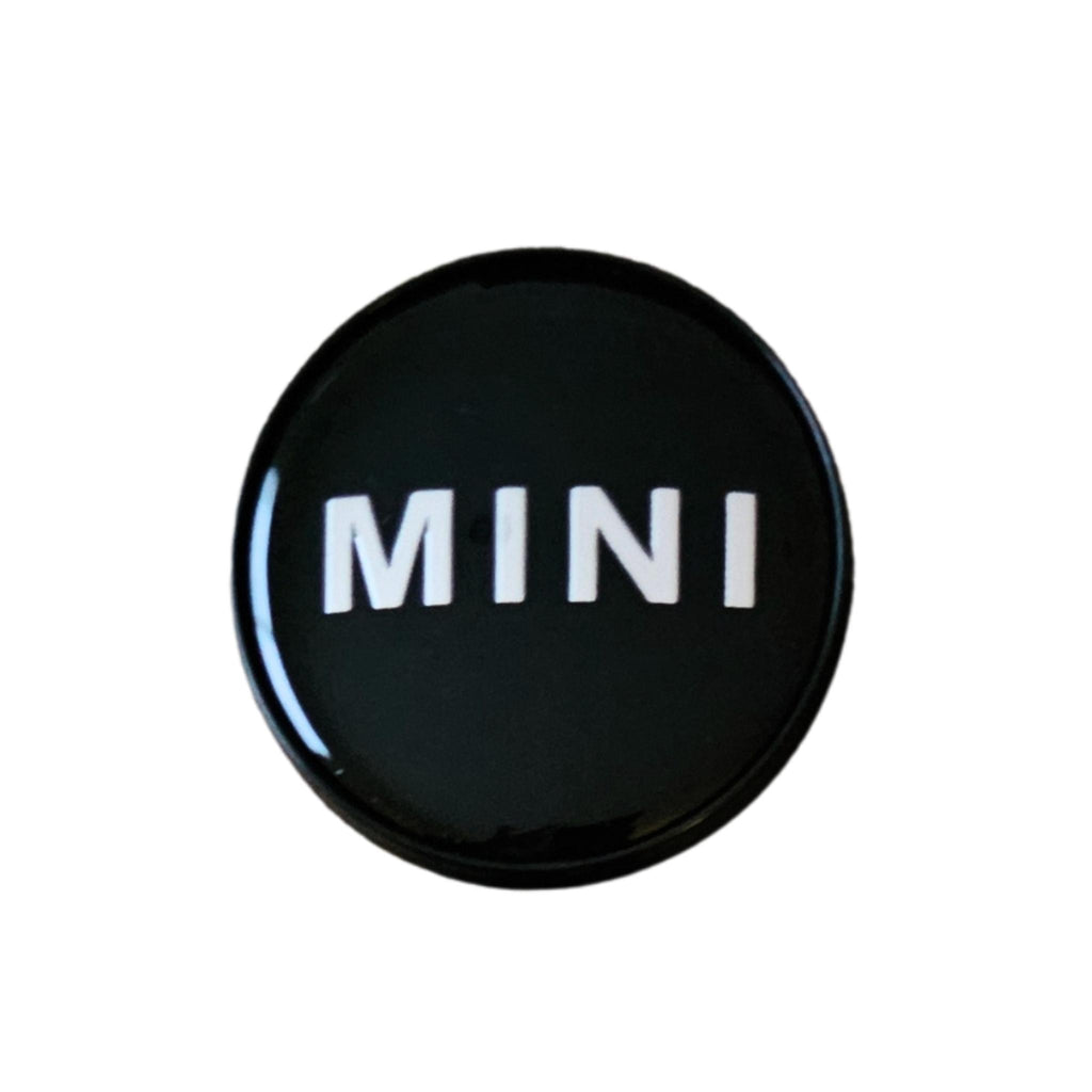 Single MINI 54mm Text Logo Wheel Centre Caps Gloss on a white background