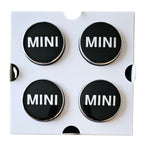 Four MINI 56mm Dynamic Floating Wheel Centre Caps on white backing card