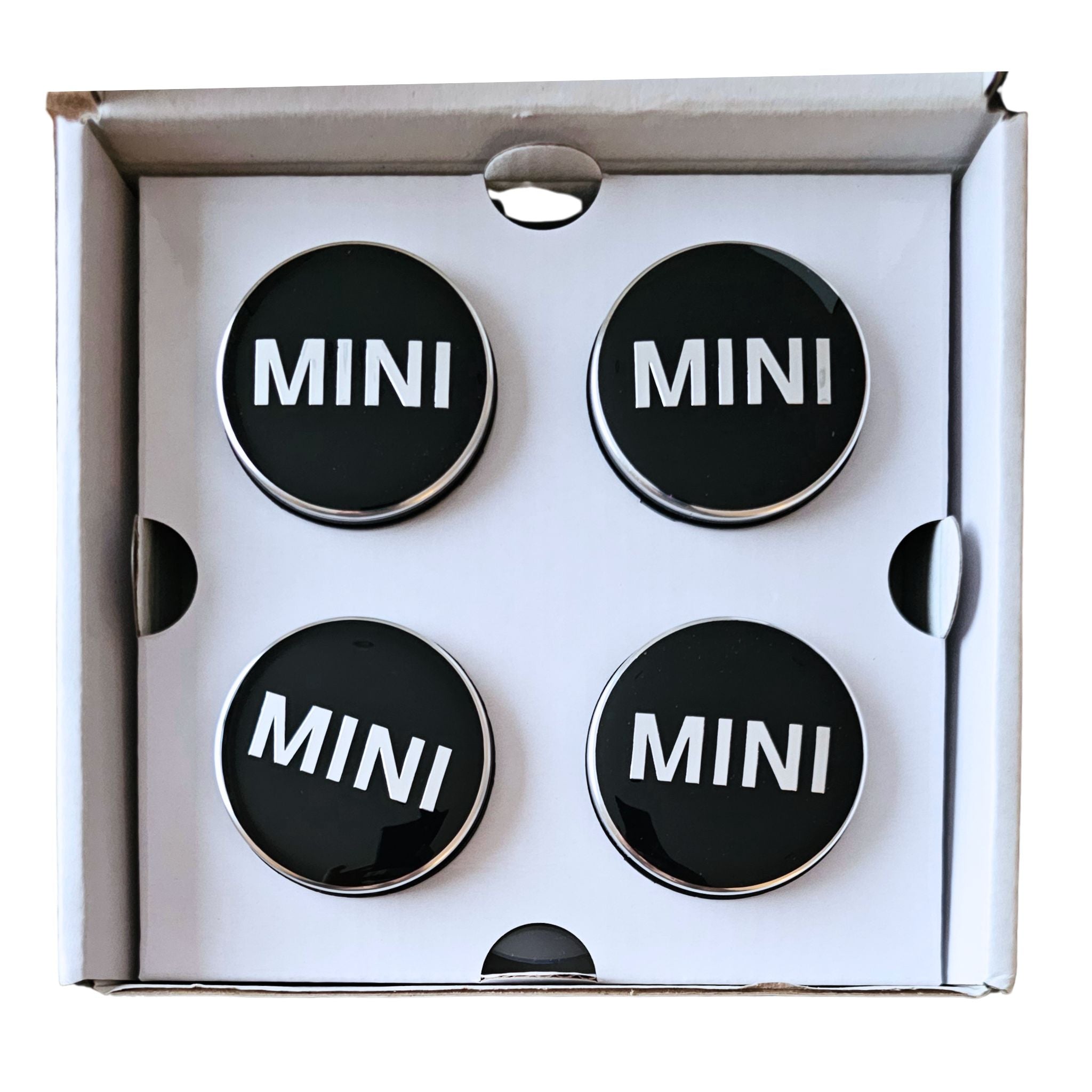 Four MINI 56mm Floating Wheel Centre Caps in open box on a white background