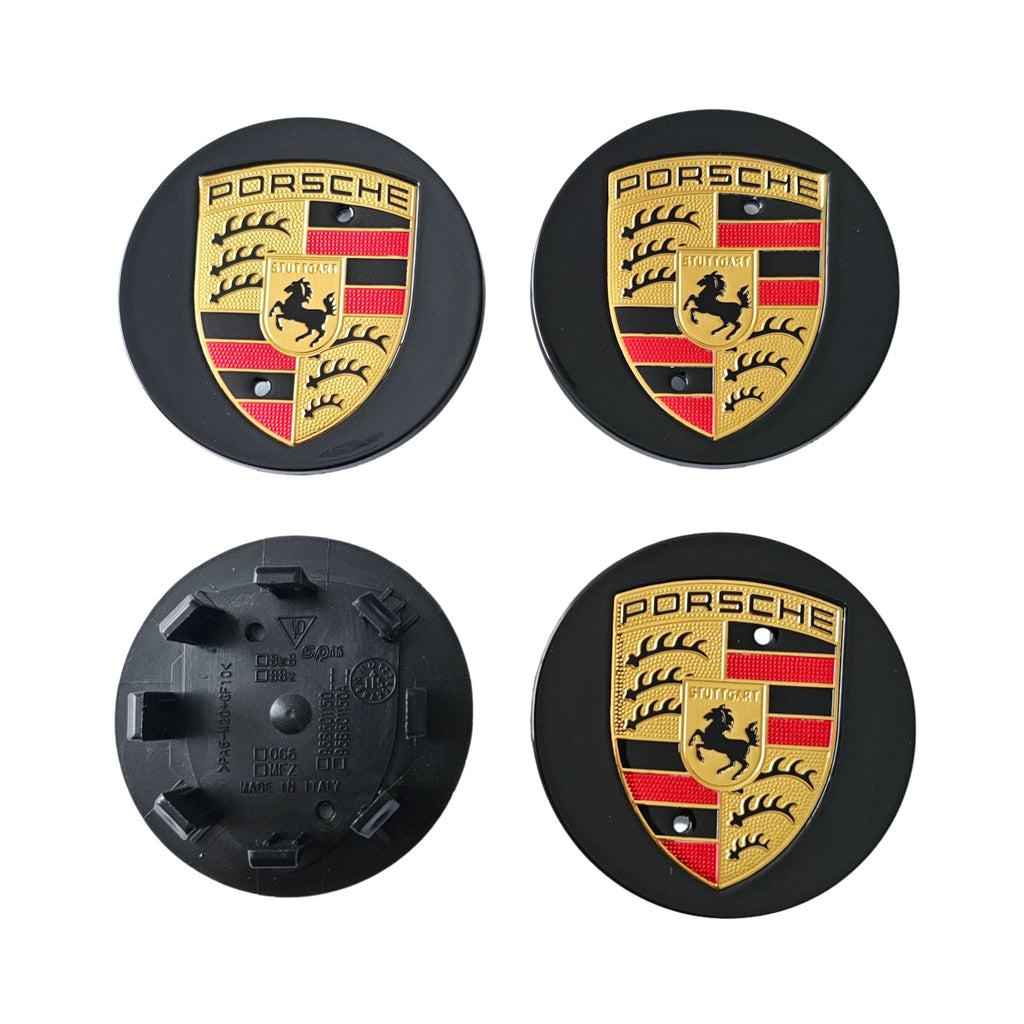 Four 65mm porsche wheel centre caps in black one face down  on white background