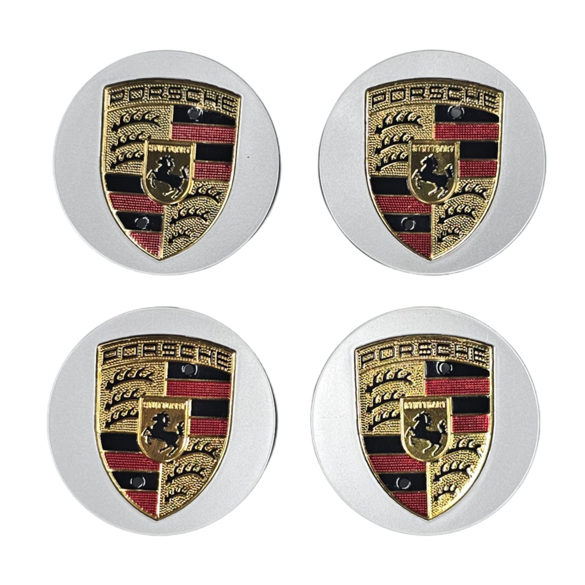 Four Porsche logo car wheel center caps on a white background