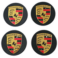 Four Black Porsche 76mm Wheel Centre Caps on white background
