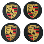 Four Black Porsche 76mm Wheel Centre Caps on white background
