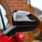 VW Golf Mk7 & Mk7.5 Gloss Black Mirror Covers fitted on a red vehicle
