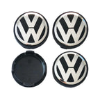 Four 56mm VW Volkswagen logo car wheel center caps on a white background