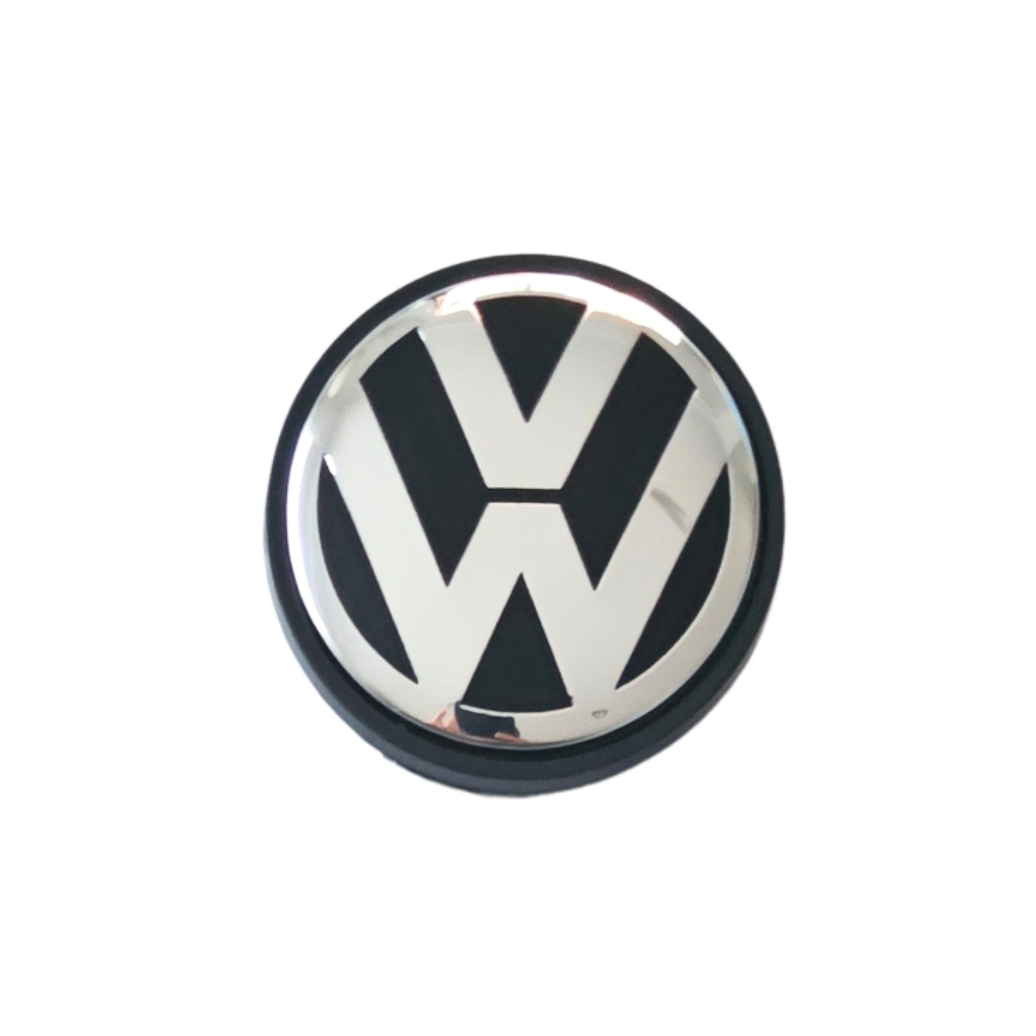 Single Volkswagen 56mm wheel centre cap with VW logo on a white background