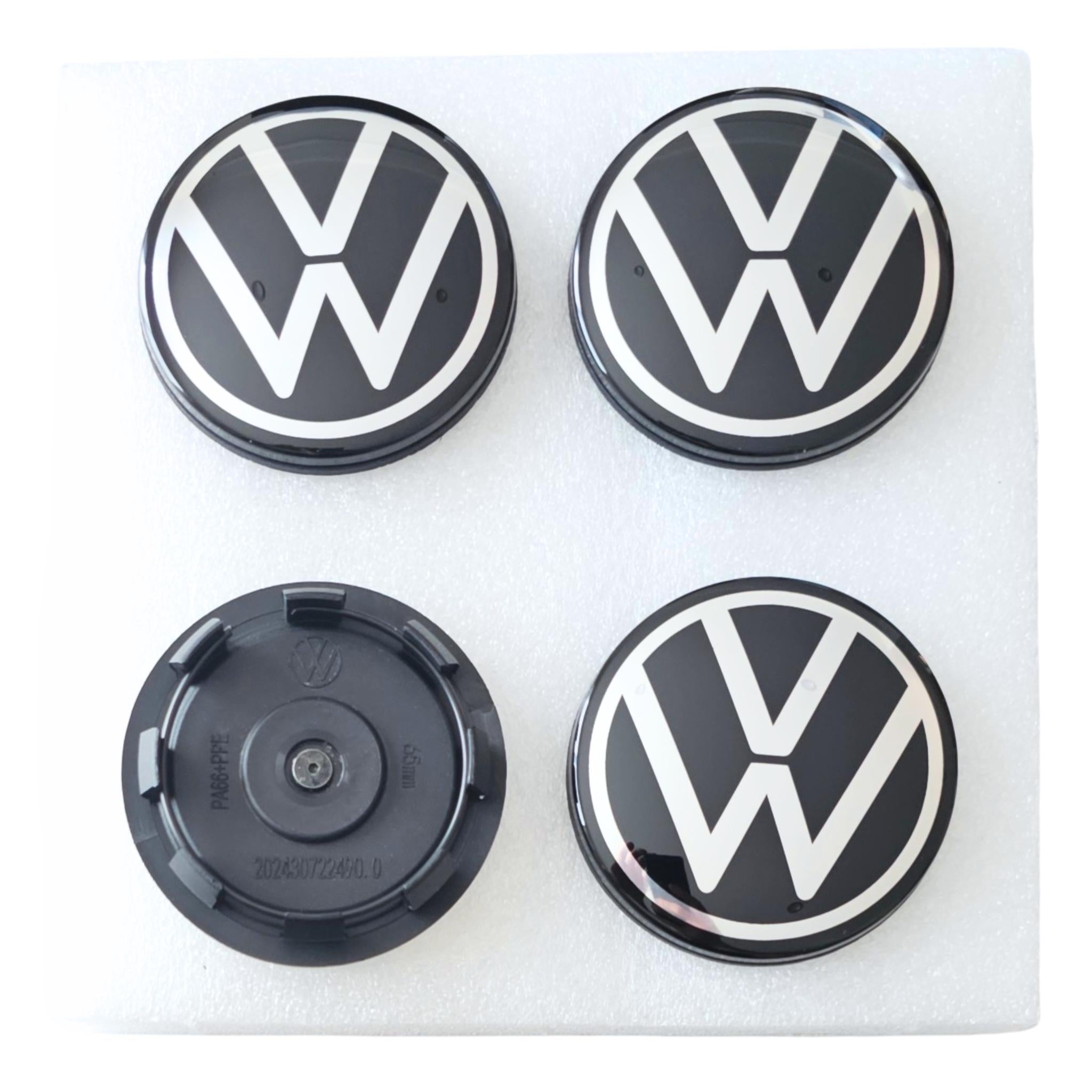 Four 65mm Floating Dynamic Volkswagen logo car wheel center caps on a white background