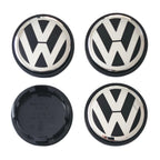 Four 65mm VW Volkswagen logo car wheel center caps on a white background
