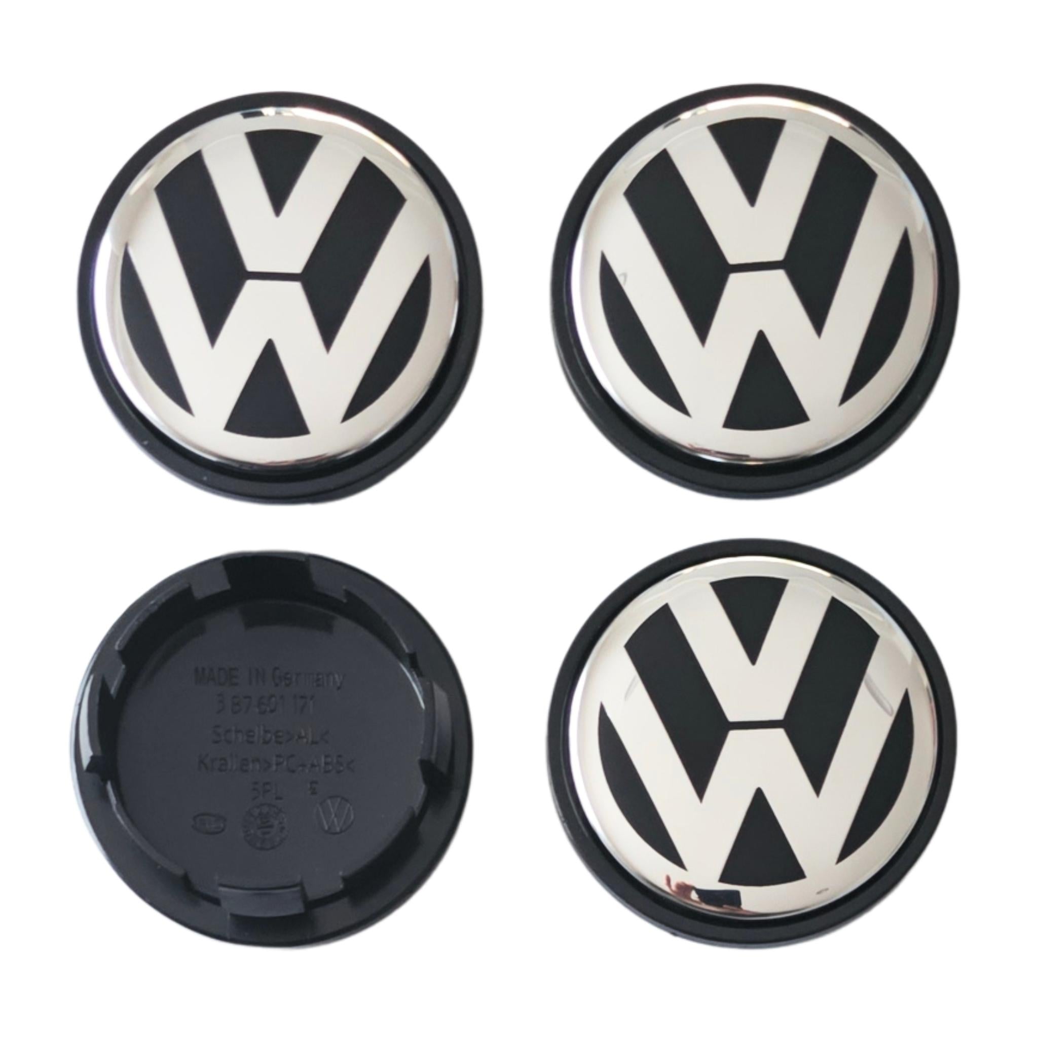 Four 65mm VW Volkswagen logo car wheel center caps on a white background